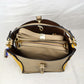 Studded Two-Tone Bucket Bag with Top Handle and Decorative Strap