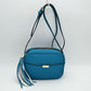 Pebbled Camera Crossbody Bag with Large Statement Tassel Accent