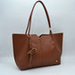 Minimalist Structured Tote Bag with Geometric Cutout and Tassel Accent