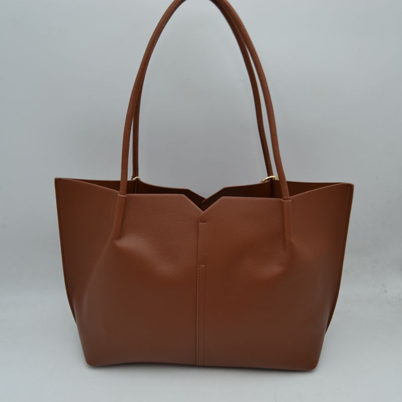 Minimalist Structured Tote Bag with Geometric Cutout and Tassel Accent