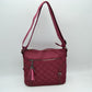 Quilted Nylon Crossbody Bag with Buckle Accents and Tassel Charm