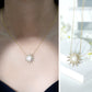 Collar con colgante en forma de sol con perla natural de agua dulce y diamantes