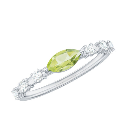 Anillo de peridoto de 0,75 quilates en orientación este-oeste con acento de diamante