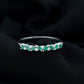 Anillo de media eternidad de esmeraldas y diamantes marquesa