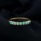 Anillo de media eternidad de esmeraldas y diamantes marquesa