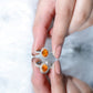 Anillo de compromiso de ópalo de fuego ovalado de 1 quilate con halo de diamantes