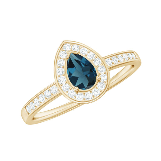 Anillo de Compromiso de Topacio Azul Londres con Forma de Pera de 0,7 Quilates con Halo de Diamantes