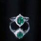 Vintage Looking Emerald Oval Engagement Ring with Diamond Halo