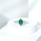 Vintage Looking Emerald Oval Engagement Ring with Diamond Halo