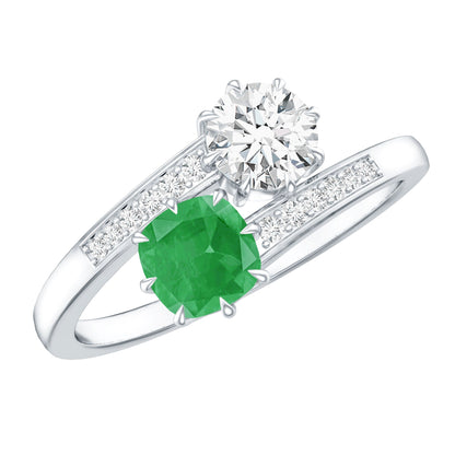Anillo de compromiso de dos piedras de esmeralda y moissanita con vástago cruzado