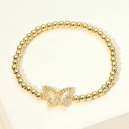 Brazalete elástico de acero inoxidable con dije de mariposa de circonita cúbica pavimentada y cuentas