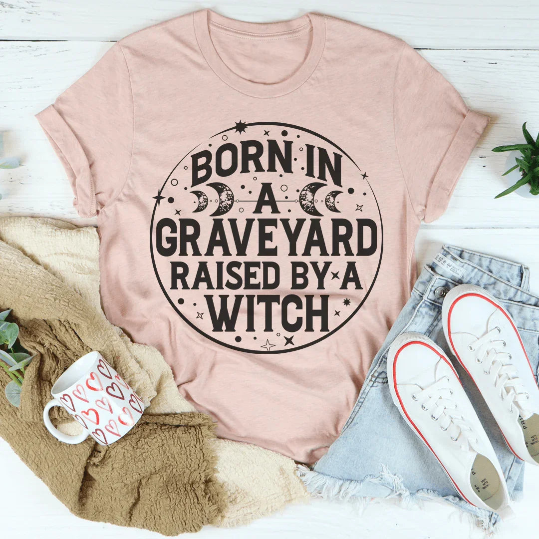 Witchy Dark Humor Top – "Born In A Graveyard Raised By A Witch" Graphic T-Shirt