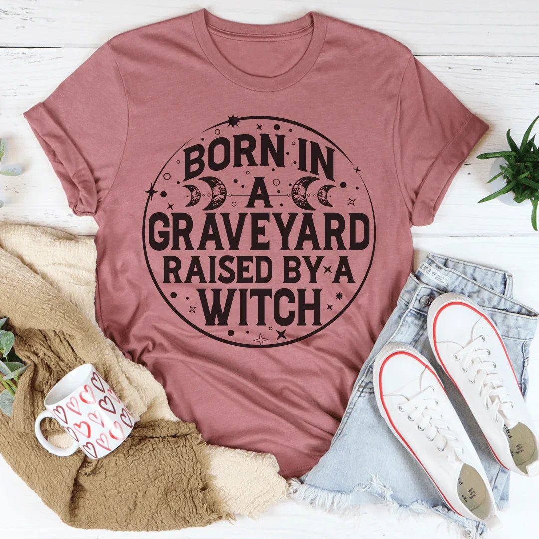 Witchy Dark Humor Top – "Born In A Graveyard Raised By A Witch" Graphic T-Shirt