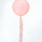 Cola de borlas de papel en colores pastel rosa y amarillo